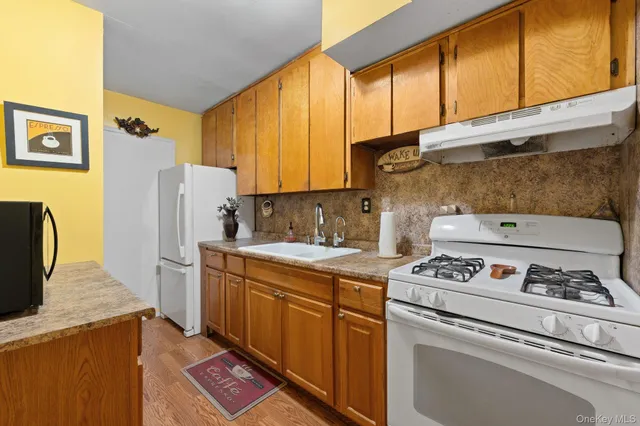 a kitchen with a stove a refrigerator and a sink