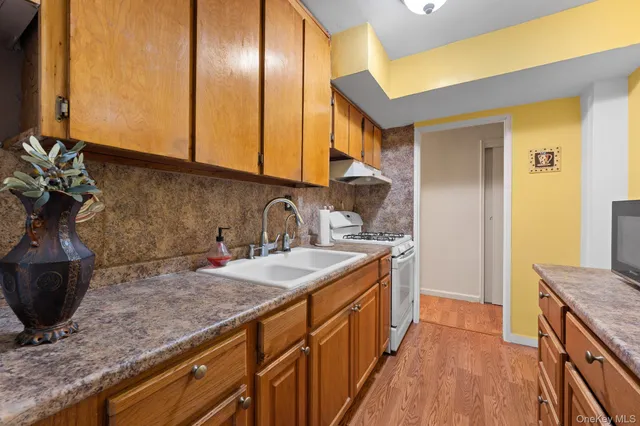 a kitchen with stainless steel appliances granite countertop a sink stove and cabinets