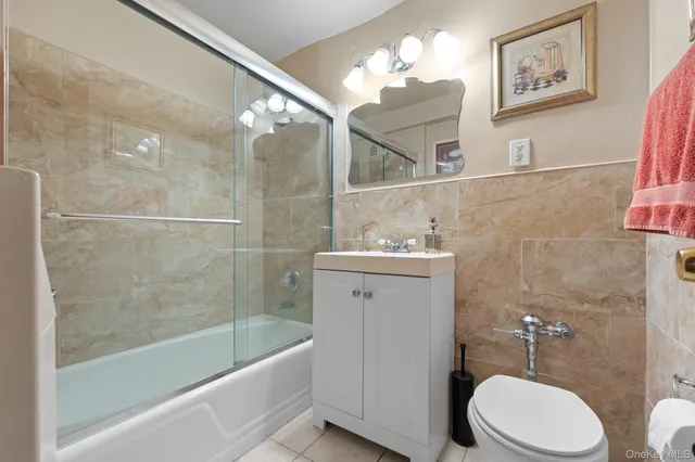 a bathroom with a sink mirror vanity and toilet
