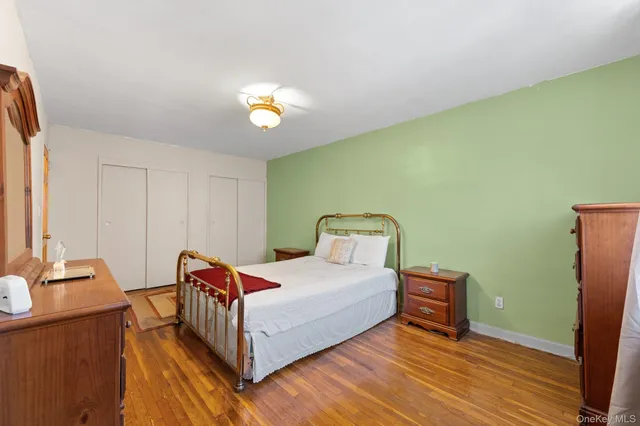 a bedroom with a bed and a lamp on table