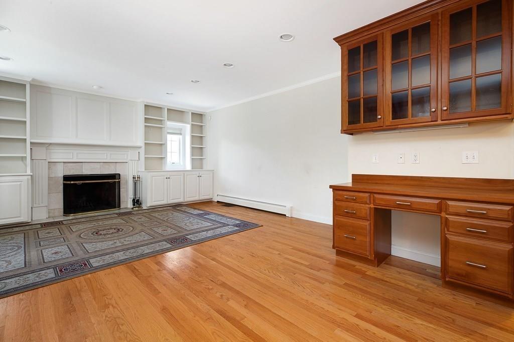31 Fuller Road Needham, MA 02492 - Photo 16 of 42 a view of empty room with wooden floor and fireplace