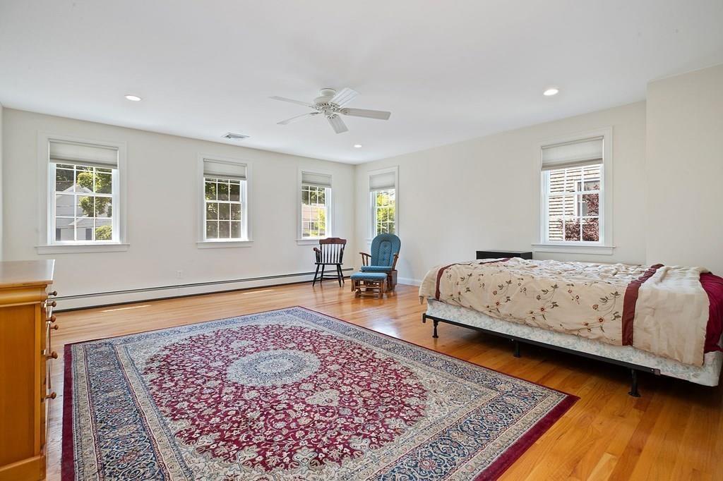 31 Fuller Road Needham, MA 02492 - Photo 19 of 42 a bedroom with a bed and wooden floor