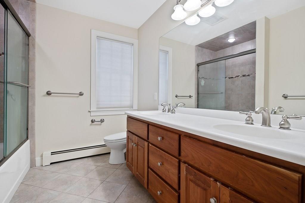 31 Fuller Road Needham, MA 02492 - Photo 23 of 42 a bathroom with a double vanity sink mirror and toilet