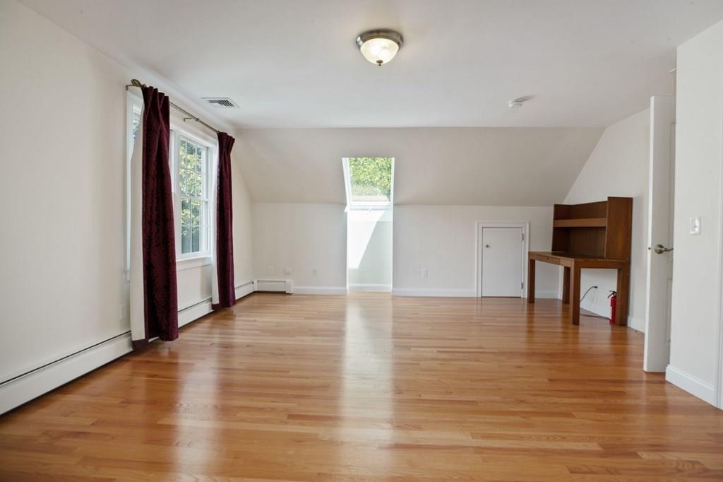 31 Fuller Road Needham, MA 02492 - Photo 30 of 42 a view of an empty room with window and wooden floor