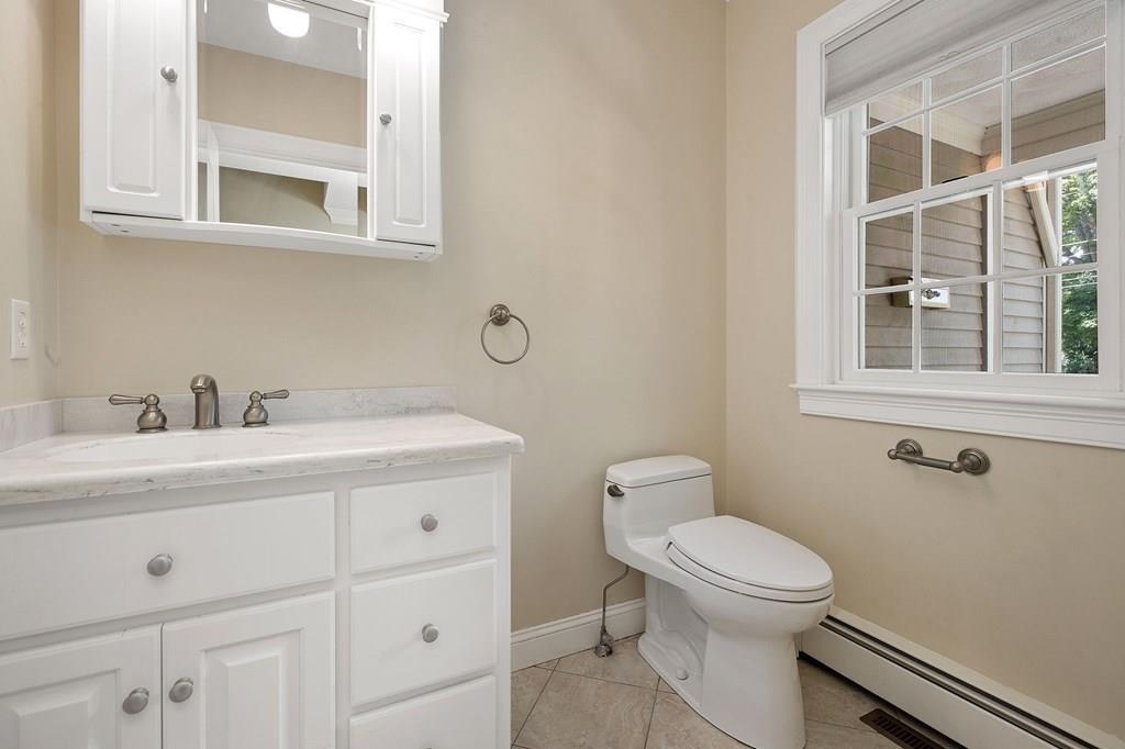 31 Fuller Road Needham, MA 02492 - Photo 5 of 42 a bathroom with a toilet a sink and a mirror