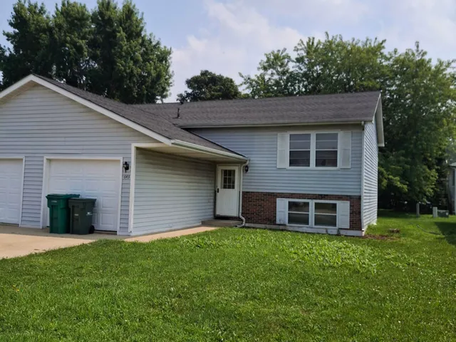 a view of a brick house with a yard
