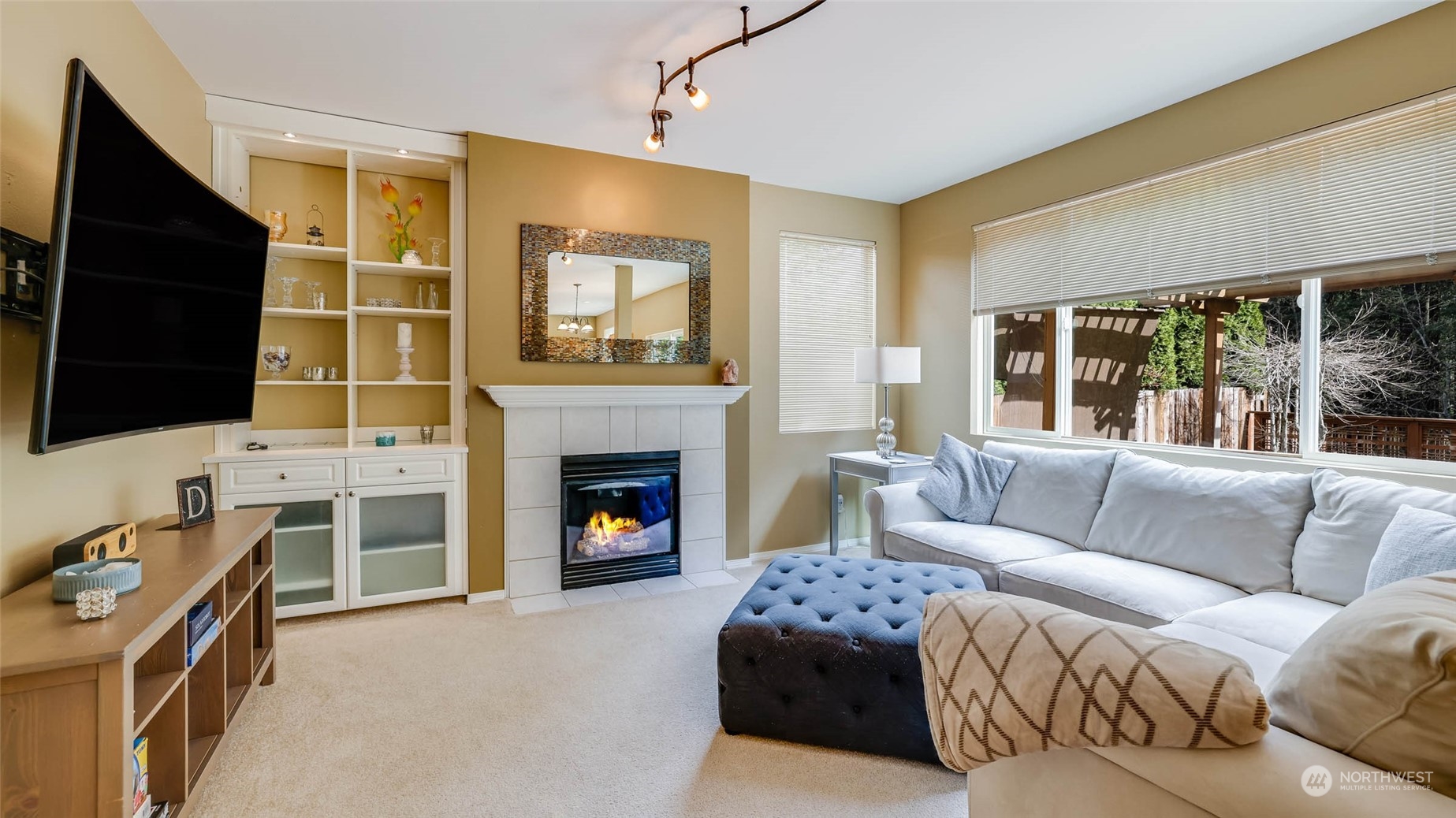 28120 Maple Ridge Way Southeast Maple Valley, WA 98038 - Photo 14 of 36 a living room with furniture flat screen tv and a fireplace