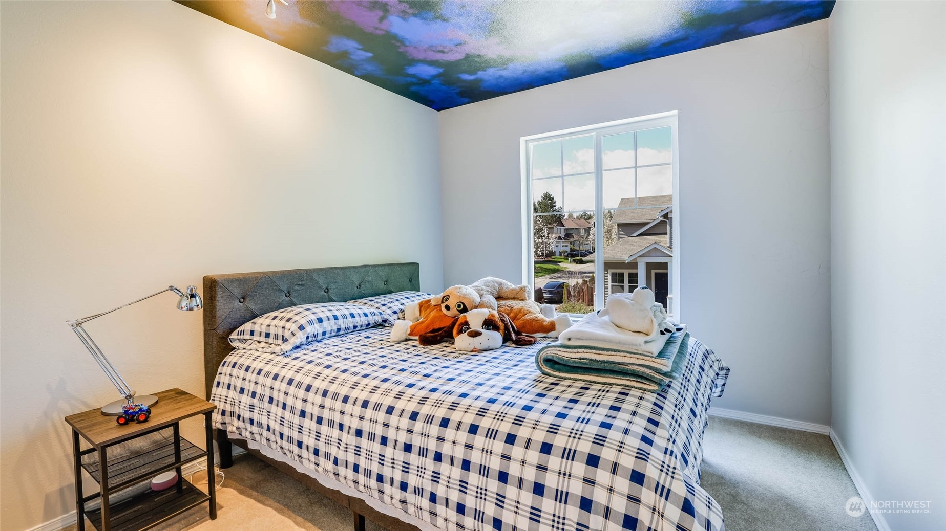 28120 Maple Ridge Way Southeast Maple Valley, WA 98038 - Photo 21 of 36 a bedroom with a bed and wooden floor