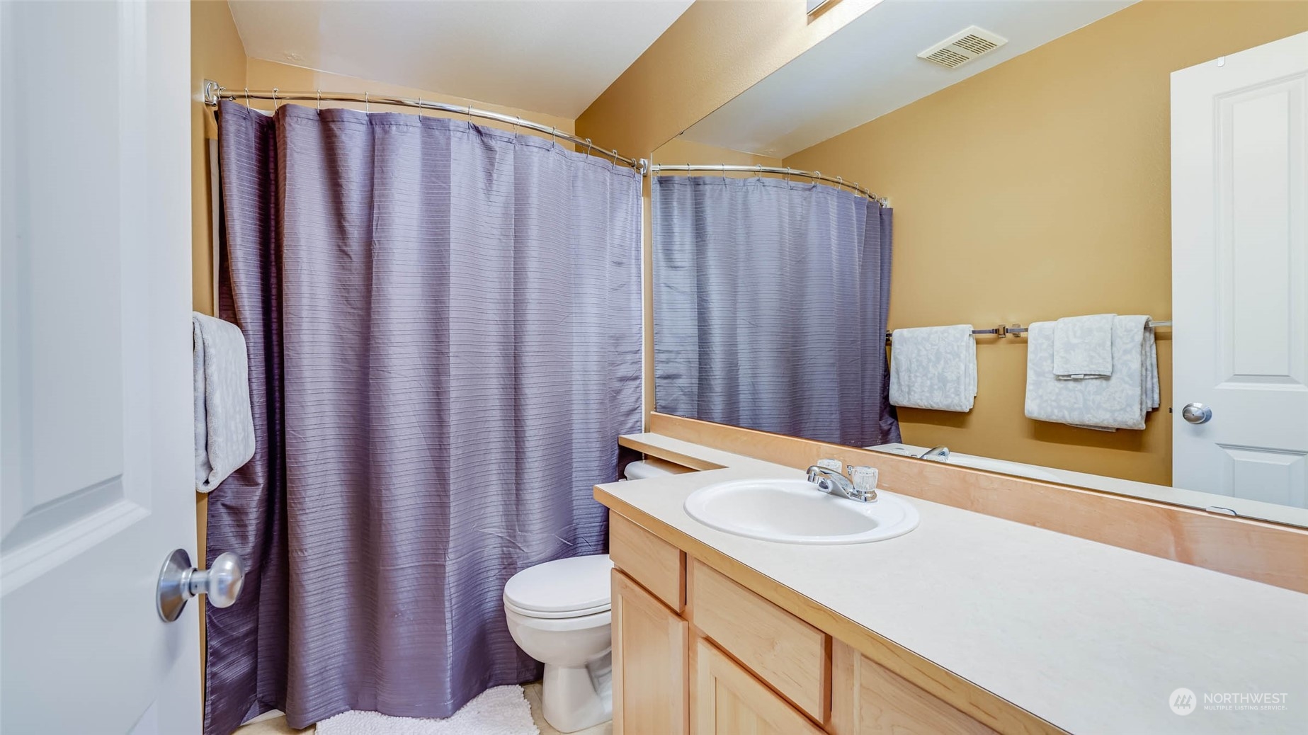 28120 Maple Ridge Way Southeast Maple Valley, WA 98038 - Photo 24 of 36 a bathroom with a sink a toilet and shower curtain
