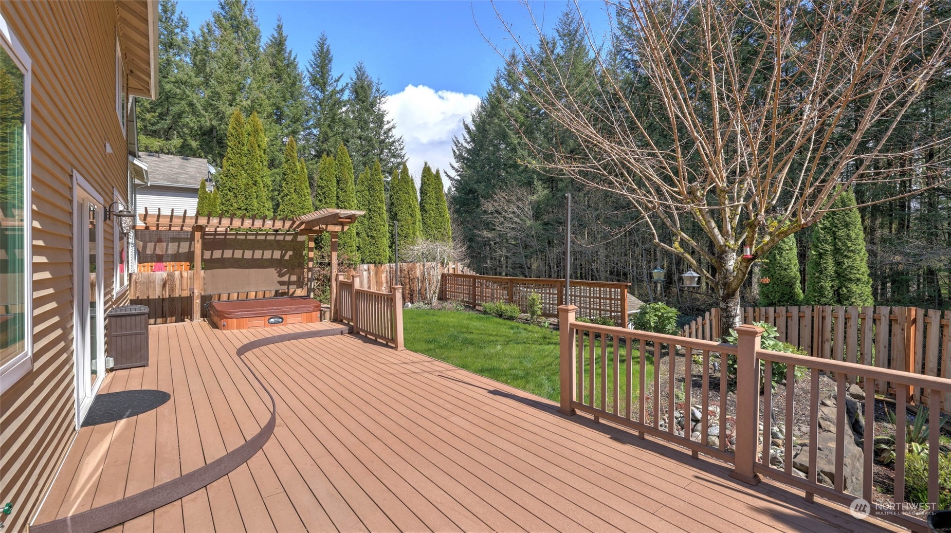 28120 Maple Ridge Way Southeast Maple Valley, WA 98038 - Photo 25 of 36 a view of a deck with two chairs and a table with wooden fence