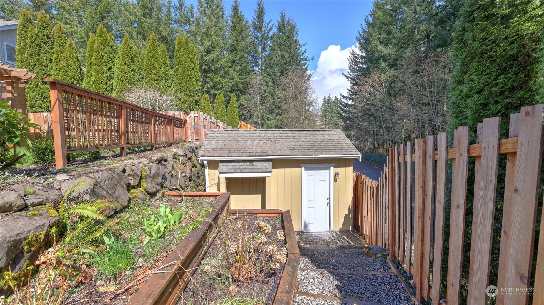 28120 Maple Ridge Way Southeast Maple Valley, WA 98038 - Photo 32 of 36 a front view of a house with a garden