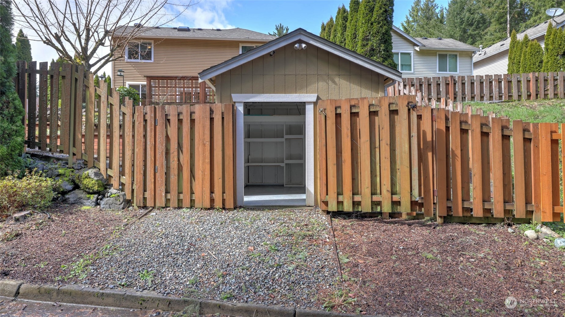 28120 Maple Ridge Way Southeast Maple Valley, WA 98038 - Photo 34 of 36 a view of a house with a wooden fence