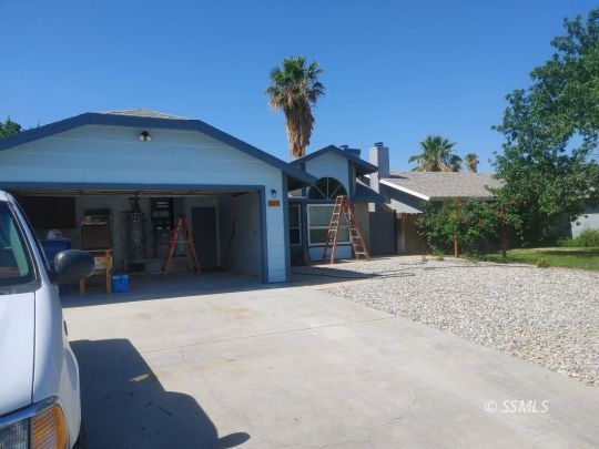 609 East Wilson Avenue Ridgecrest, CA 93555 - Photo 2 of 32 a front view of a house with a yard and garage