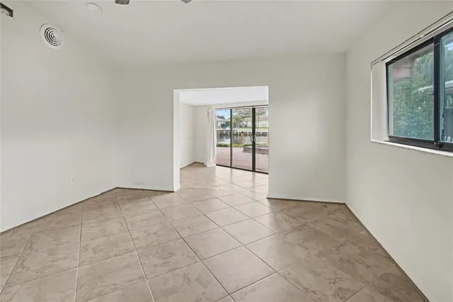 an empty room with entrance and windows