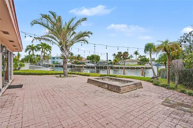 a view of swimming pool with outdoor seating and plants