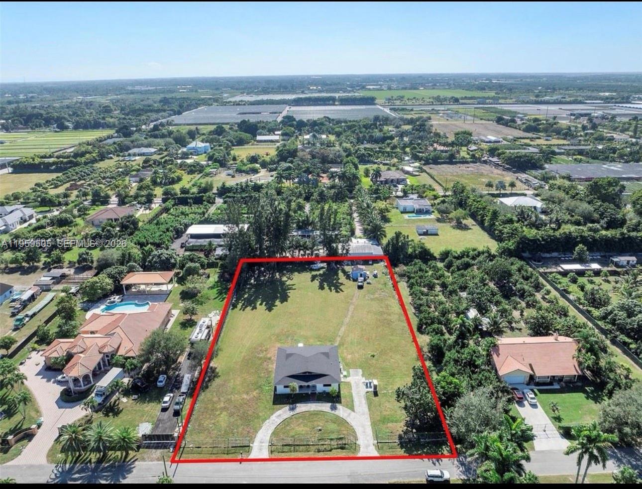 19530 Southwest 210th Street Miami, FL 33187 - Photo 1 of 20 an aerial view of residential houses with outdoor space and trees