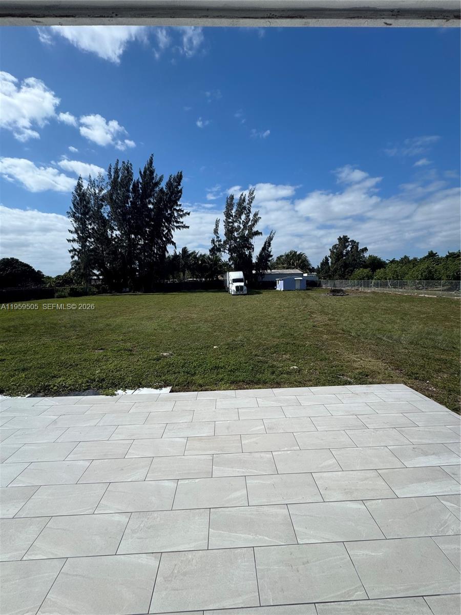 19530 Southwest 210th Street Miami, FL 33187 - Photo 18 of 20 a view of a garden with a bench