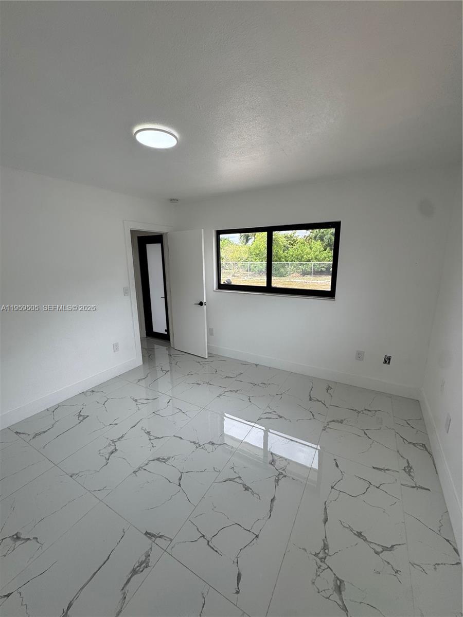 19530 Southwest 210th Street Miami, FL 33187 - Photo 19 of 20 an empty room with windows