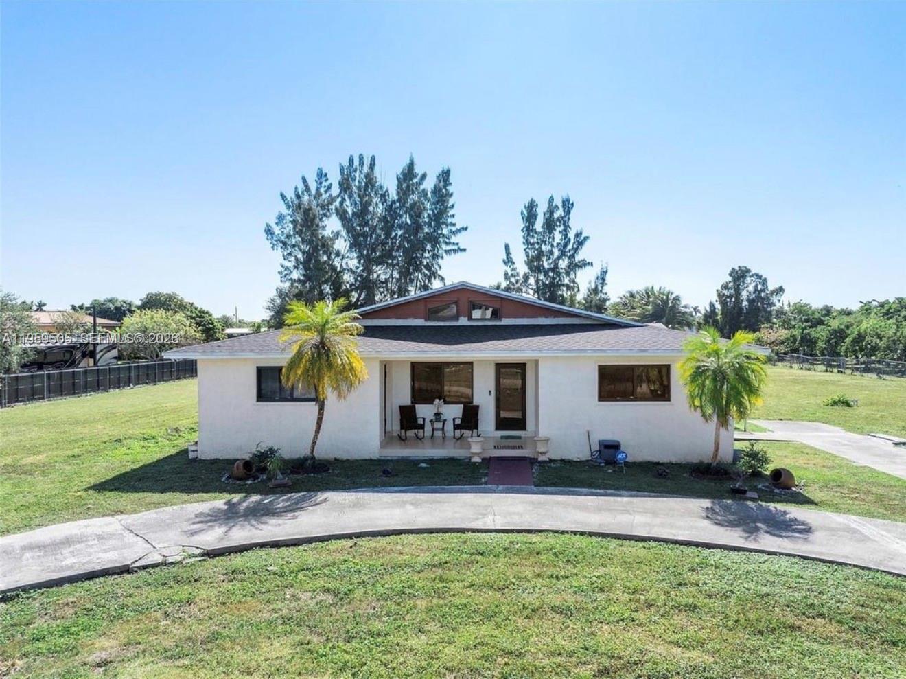 19530 Southwest 210th Street Miami, FL 33187 - Photo 2 of 20 a view of a house with backyard and sitting area