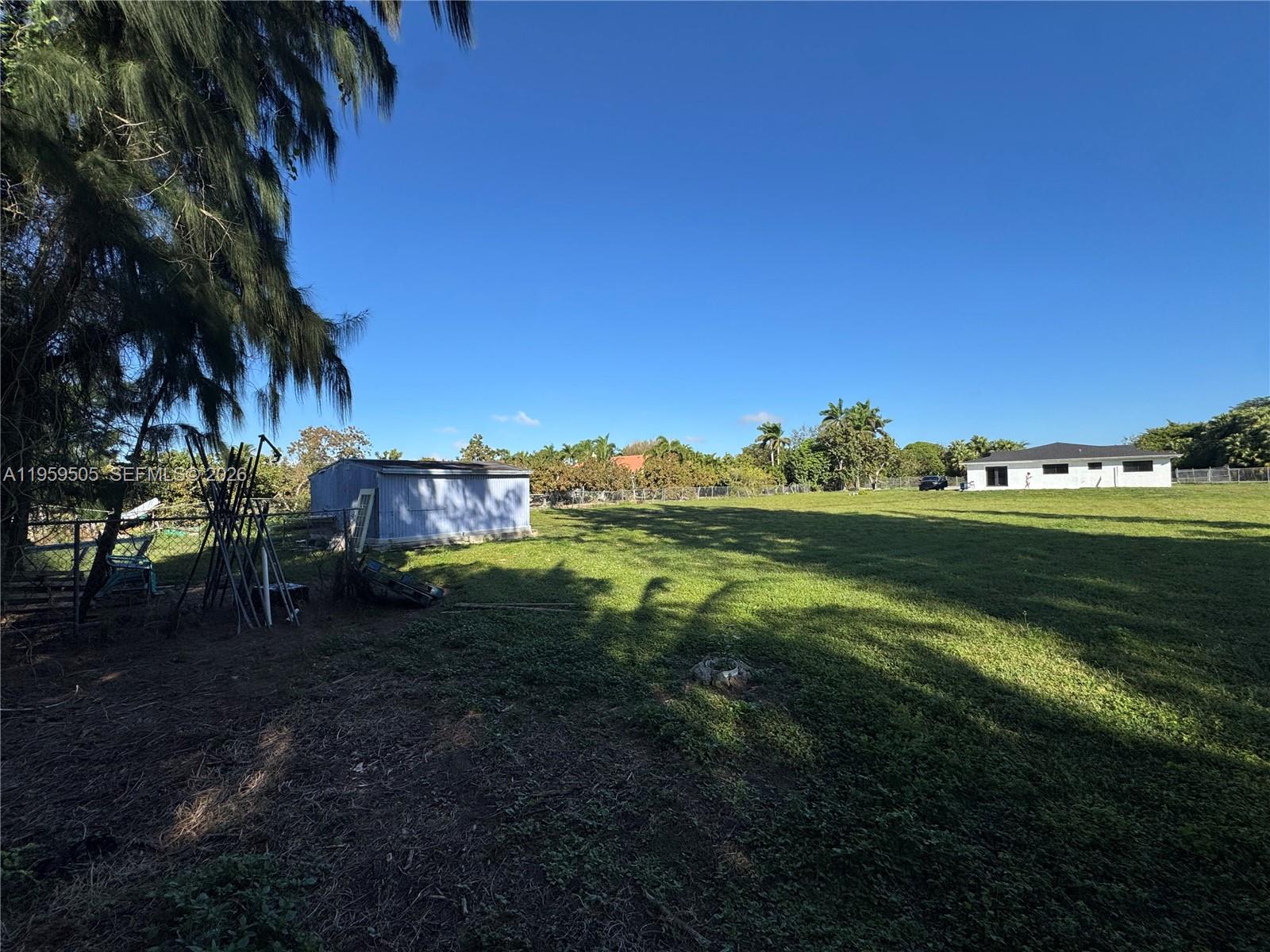 19530 Southwest 210th Street Miami, FL 33187 - Photo 4 of 20 a view of a grassy area with an trees