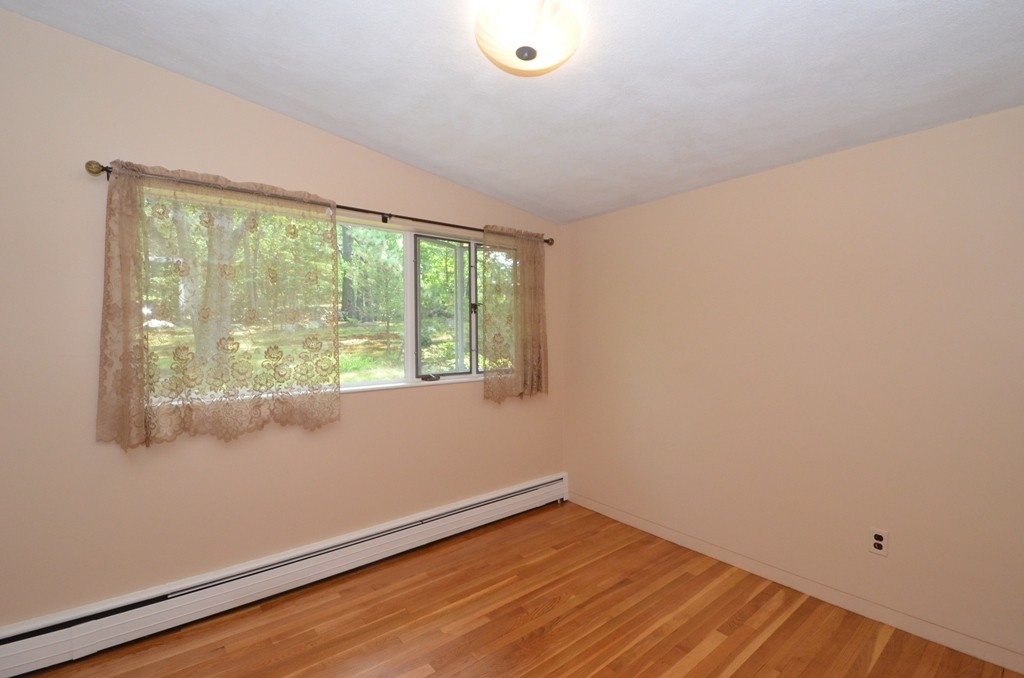 39 Peacock Farm Road Lexington, MA 02421 - Photo 15 of 30 a view of an empty room with wooden floor and a window