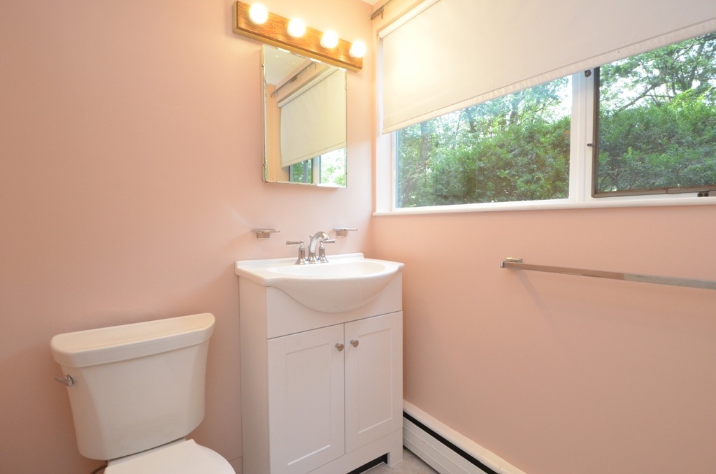 39 Peacock Farm Road Lexington, MA 02421 - Photo 21 of 30 a bathroom with a sink mirror vanity and toilet