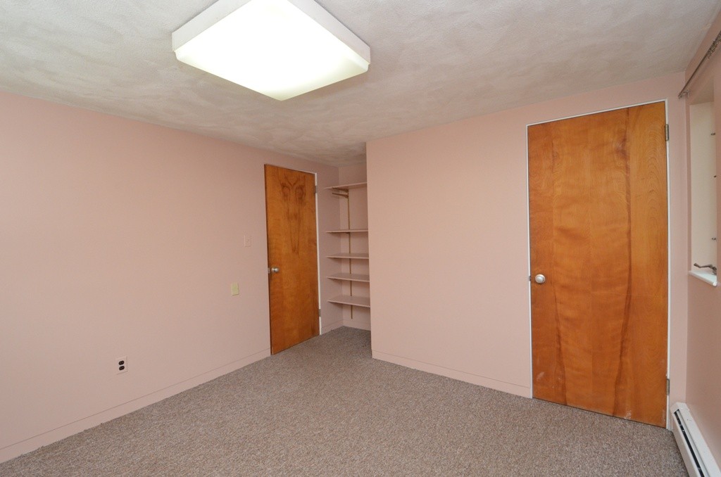 39 Peacock Farm Road Lexington, MA 02421 - Photo 23 of 30 an empty room with closet and a window