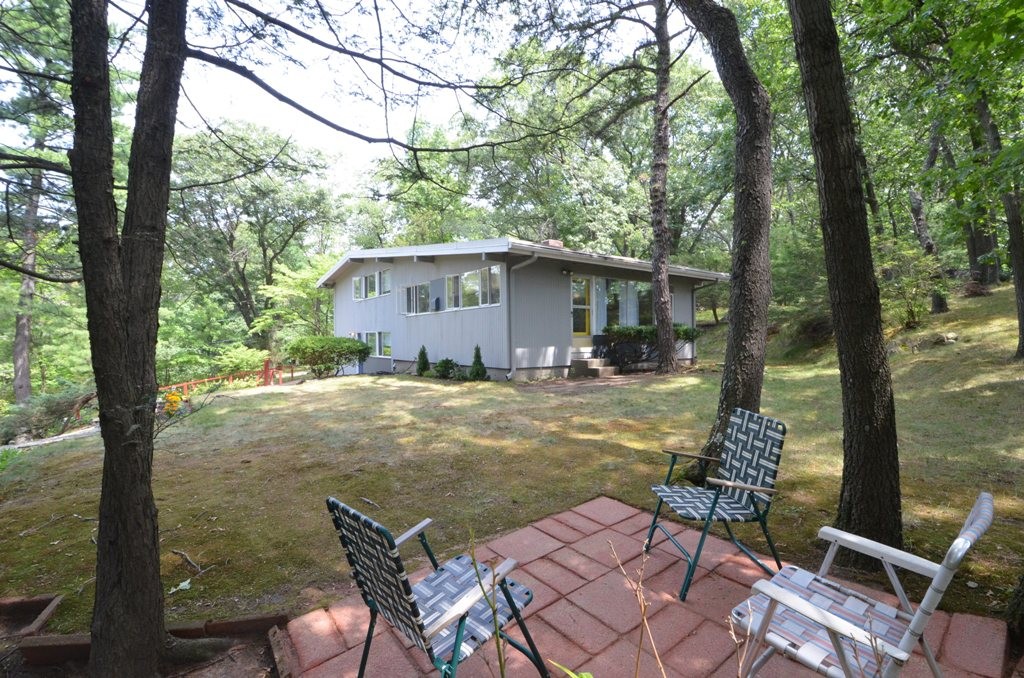 39 Peacock Farm Road Lexington, MA 02421 - Photo 24 of 30 a view of backyard with large trees and wooden fence