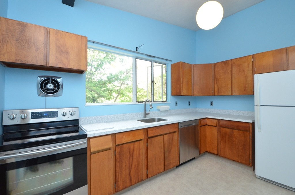 39 Peacock Farm Road Lexington, MA 02421 - Photo 8 of 30 a kitchen with a sink and a stove