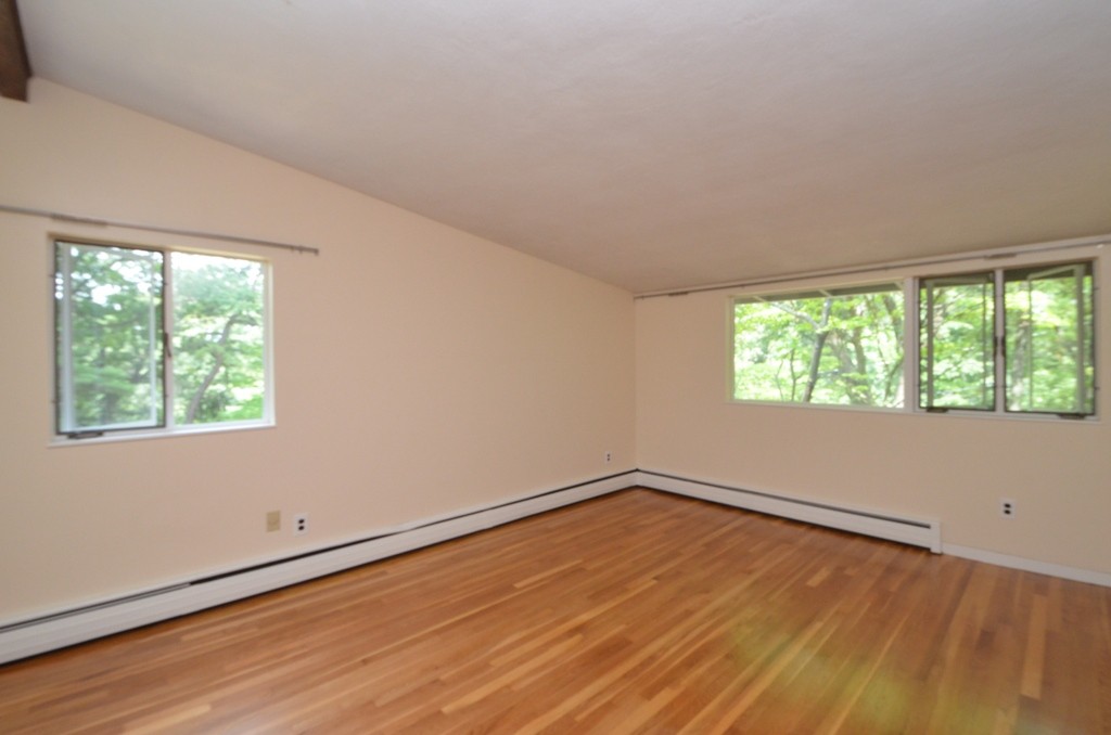 39 Peacock Farm Road Lexington, MA 02421 - Photo 10 of 30 an empty room with wooden floor and windows