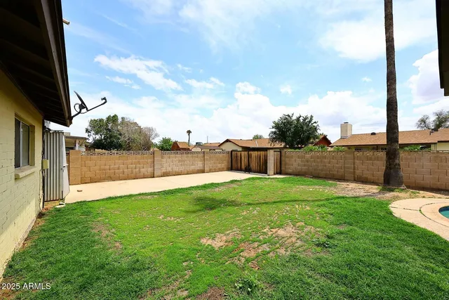 a view of backyard with swimming pool