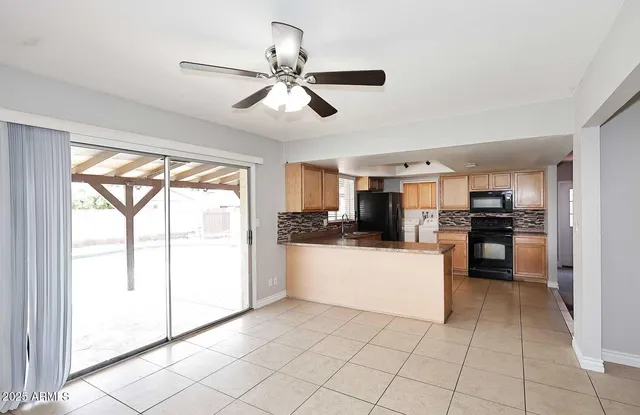 a kitchen with a refrigerator and white cabinets