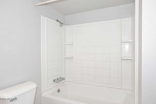 a bathroom with a bathtub a toilet and a shower