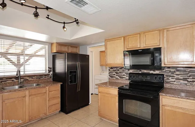 a kitchen with a refrigerator stove and microwave
