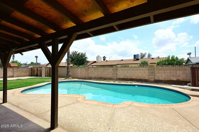 a view of a swimming pool with a patio