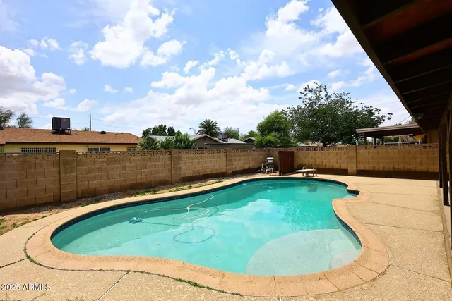 a view of a swimming pool with a backyard