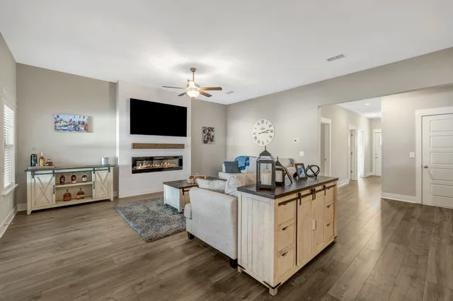 a kitchen with stainless steel appliances a sink stove and wooden floor