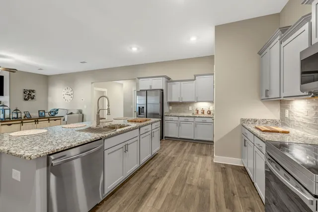 a kitchen with a sink stove top oven and cabinets