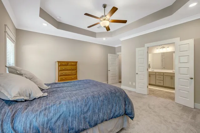 a bedroom with a bed and a ceiling fan