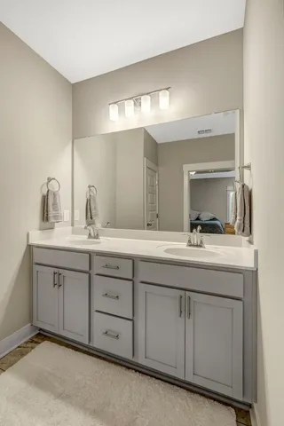 a bathroom with double sink and a mirror