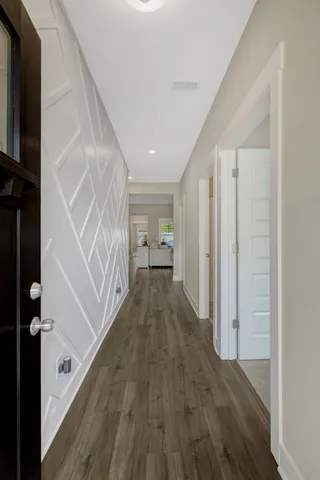 a view of hallway with wooden floor and staircase