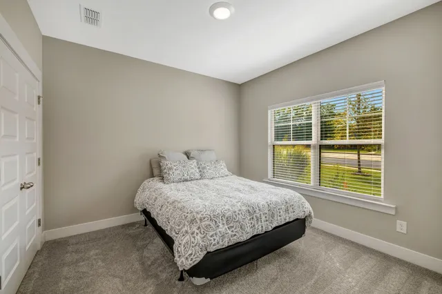 a bedroom with a bed and a window