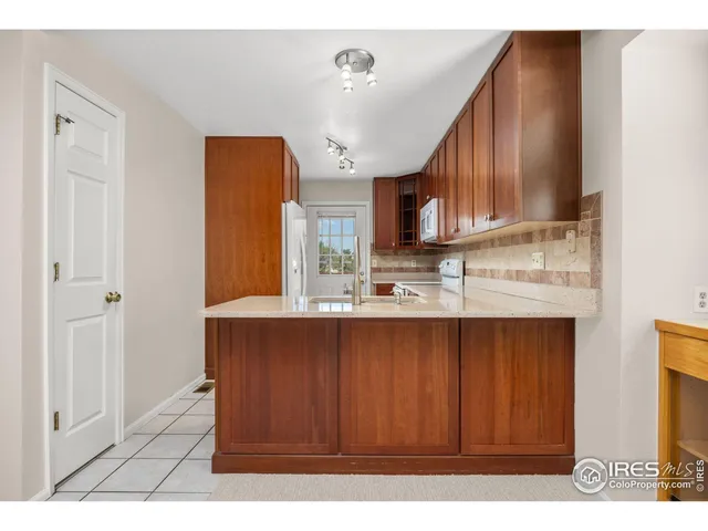 a kitchen with a sink cabinets and window