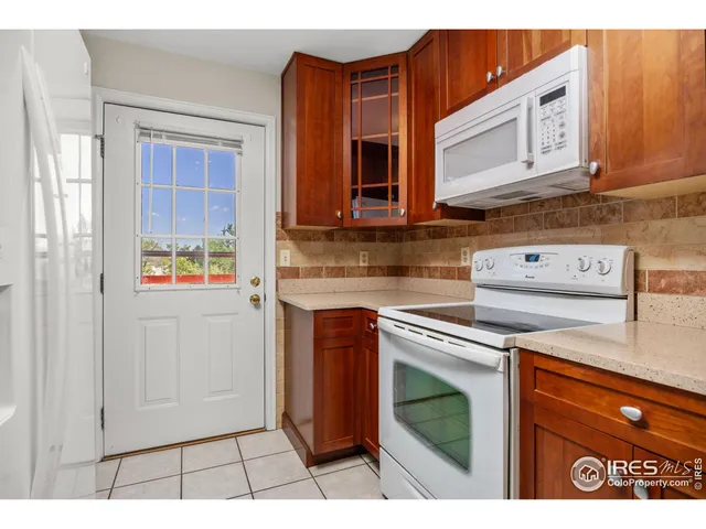 a kitchen with stainless steel appliances granite countertop a stove a microwave and a sink