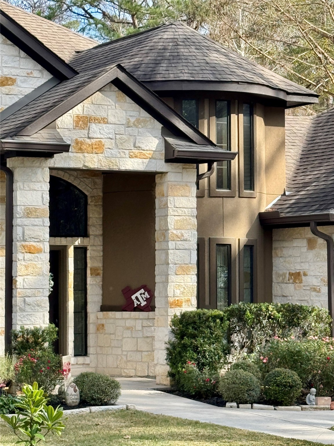 200 Harbor Run Drive Coldspring, TX 77331 - Photo 2 of 50 The focus of this image is the study. It is the curved 2 story, castle looking wall with the large windows up and down, In addition to the curved wall you see here, there is also a stone wall inside the full 2 story height. In addition to a wonderful study, office, or library, this space could be a fabulous music room, craft room, play room or used as an extra guest room. The possibilities are endless!