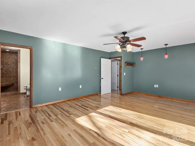 a bathroom with a granite countertop sink a toilet and a mirror