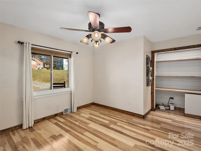 a view of empty room with wooden walls