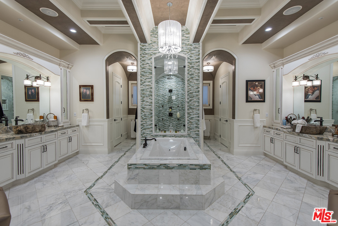 15506 Meadowgate Road Encino, CA 91436 - Photo 29 of 50 a large spacious bathroom with a double vanity sink a large mirror a bathtub and a shower