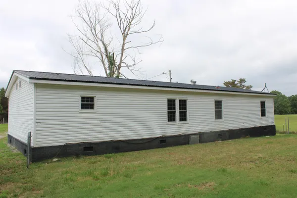 a view of a house with a backyard