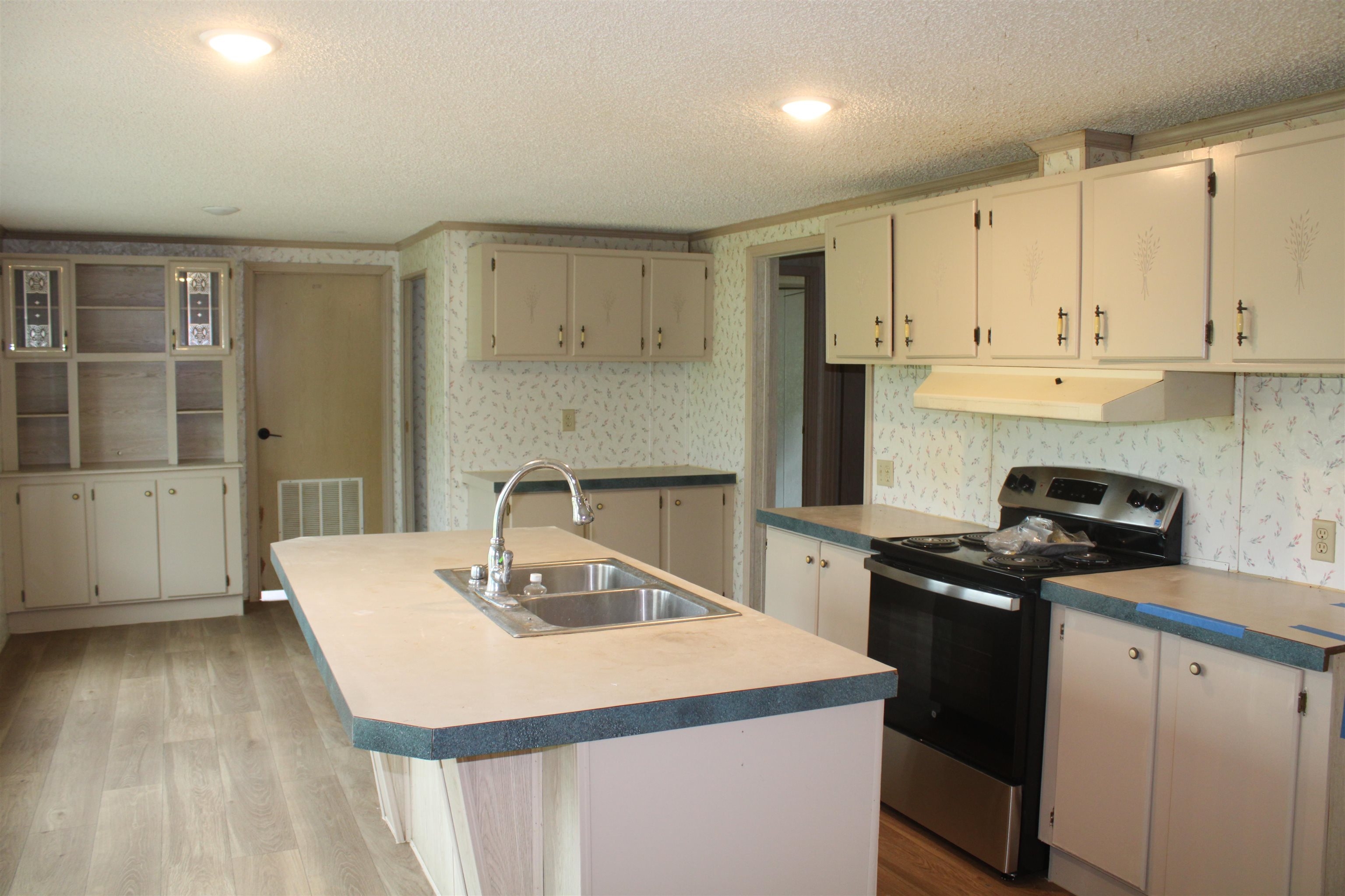 1660 Candy Owens Road Moscow, TN 38057 - Photo 11 of 14 a kitchen with a sink a stove and cabinets